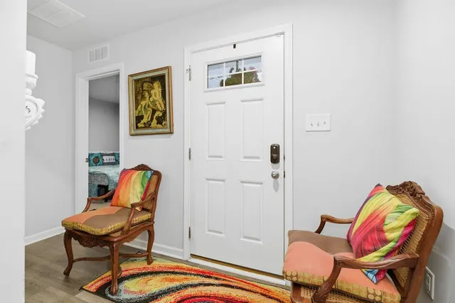 a living room with furniture and a chair