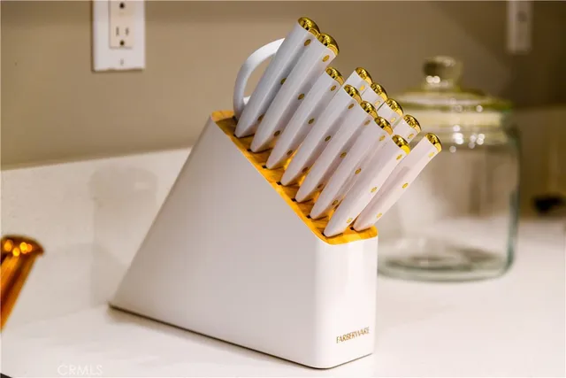 a spacious bedroom with a bed and a chandelier