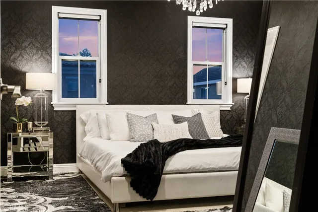 a bed sitting in a room next to a lamp