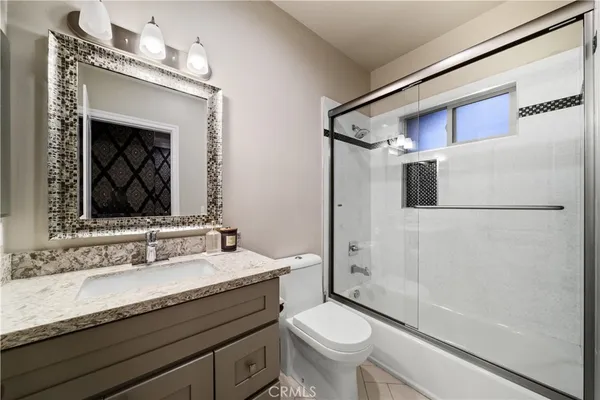 a bedroom with a large bed and a flat screen tv