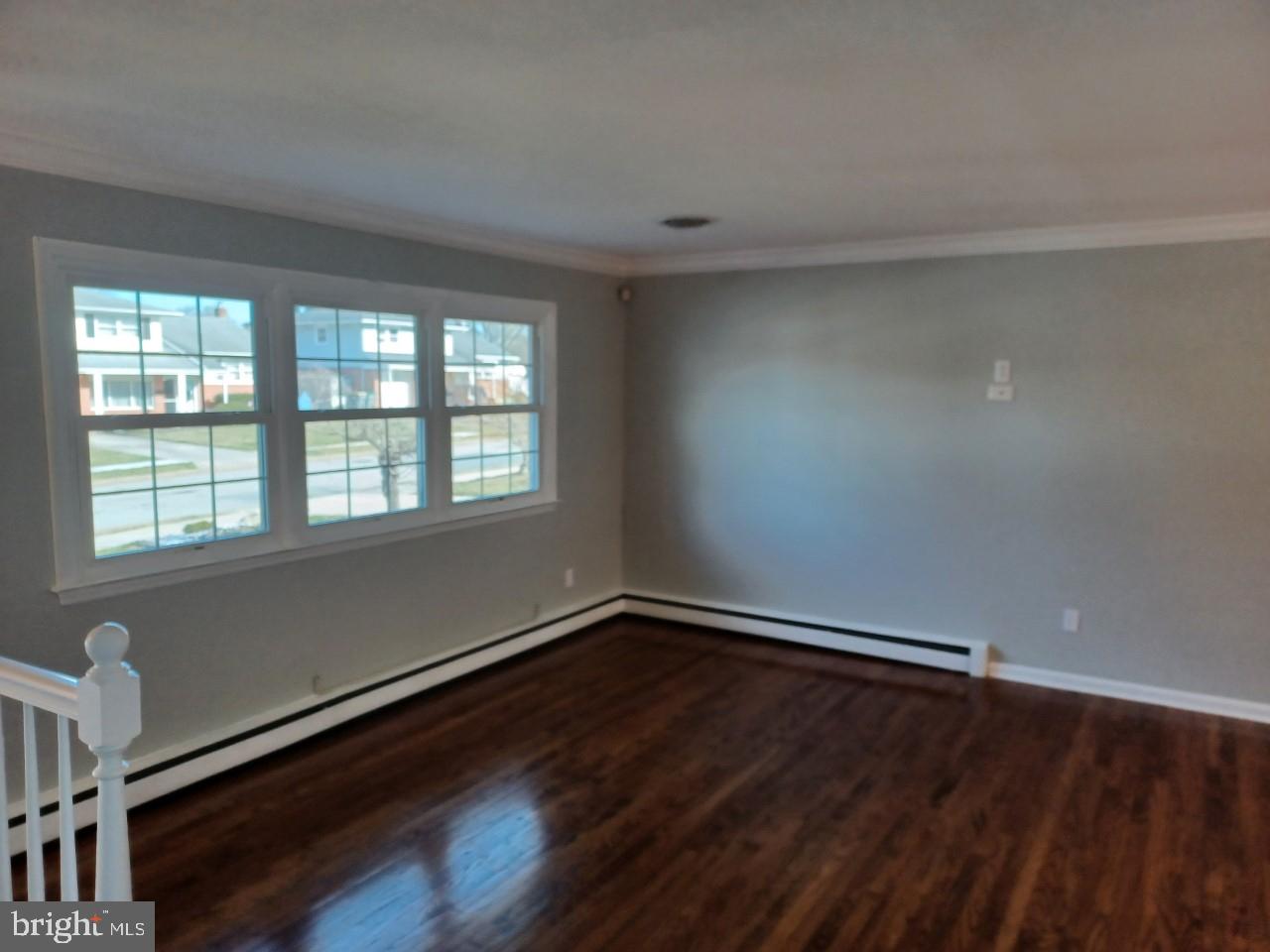 36 Windflower Drive Newark, DE 19711 - Photo 2 of 11 a view of an empty room with wooden floor and a window