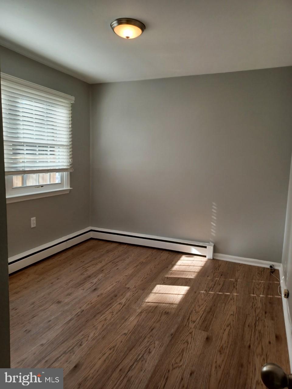 36 Windflower Drive Newark, DE 19711 - Photo 5 of 11 an empty room with wooden floor and windows