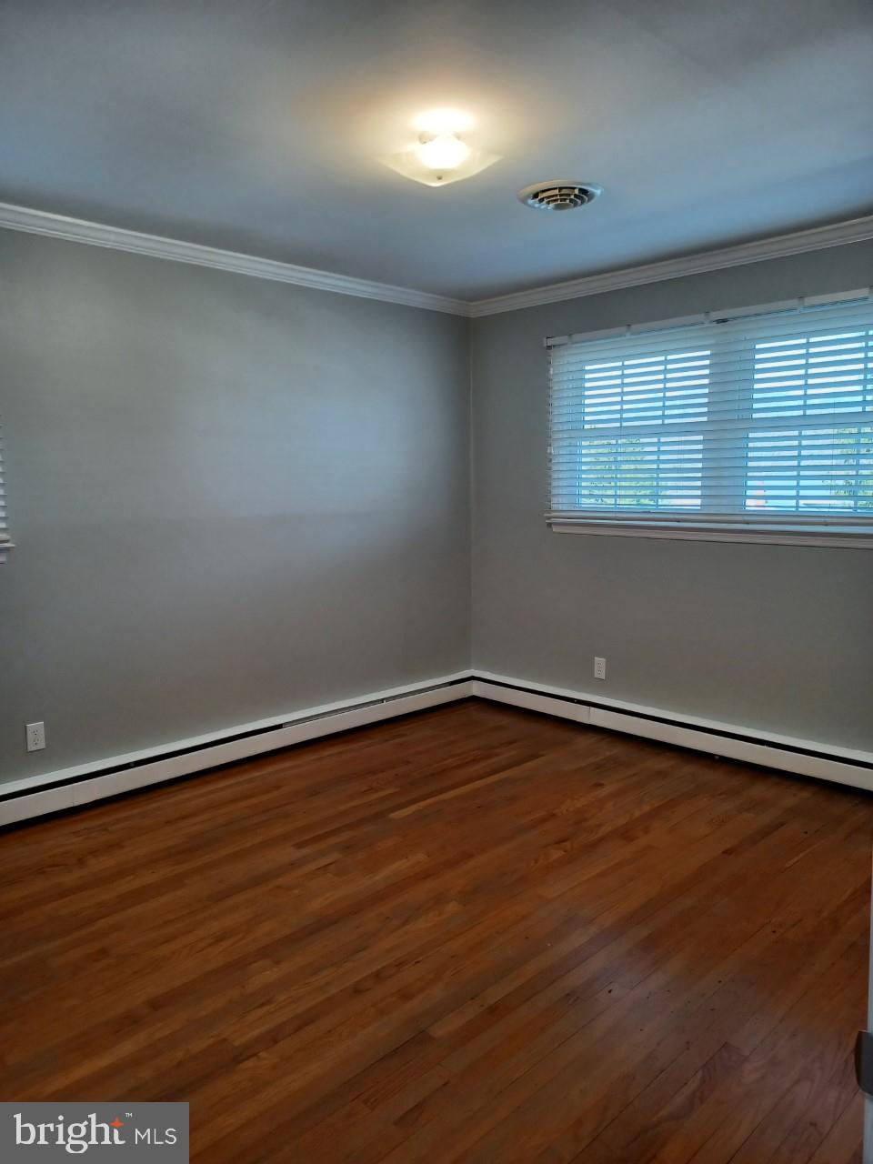 36 Windflower Drive Newark, DE 19711 - Photo 9 of 11 a view of an empty room with wooden floor and a window