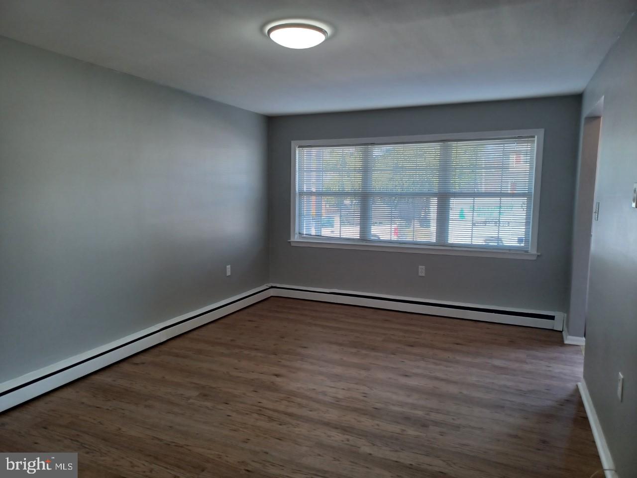 36 Windflower Drive Newark, DE 19711 - Photo 10 of 11 an empty room with wooden floor and windows