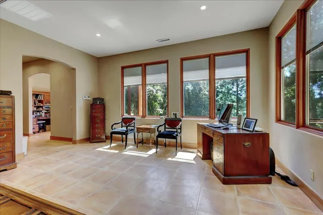a view of house with yard and trees in the background