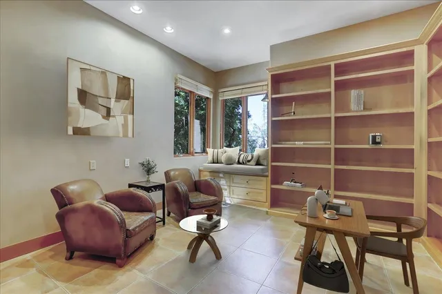 a living room with furniture and large window with outer view