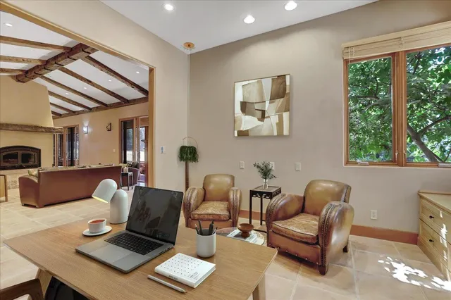 a living room with furniture a rug and a large window