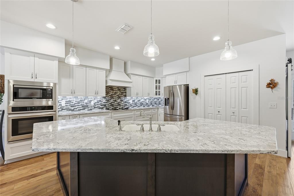 4162 Northeast 27th Lane High Springs, FL 32643 - Photo 15 of 46 a kitchen with stainless steel appliances granite countertop a sink refrigerator and microwave