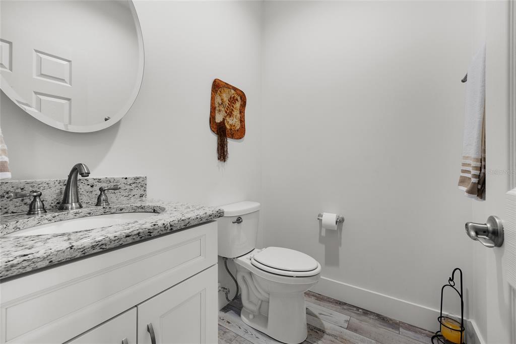 4162 Northeast 27th Lane High Springs, FL 32643 - Photo 19 of 46 a bathroom with a granite countertop sink mirror and toilet