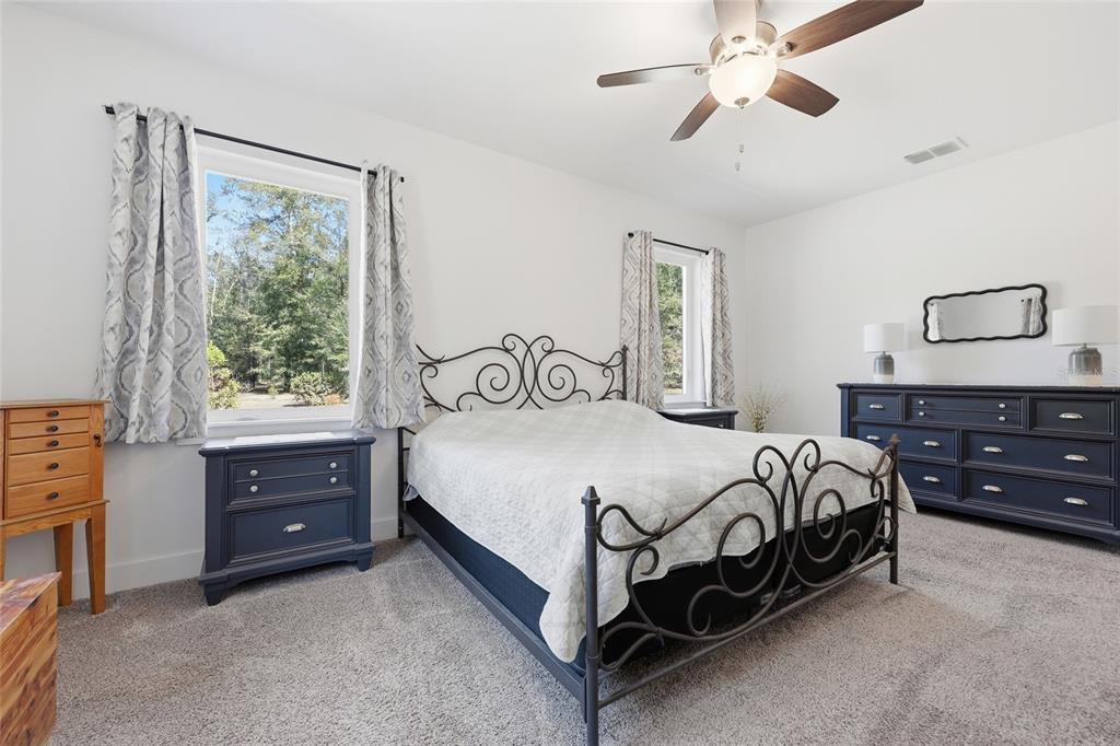 4162 Northeast 27th Lane High Springs, FL 32643 - Photo 21 of 46 a bedroom with a bed and a dresser
