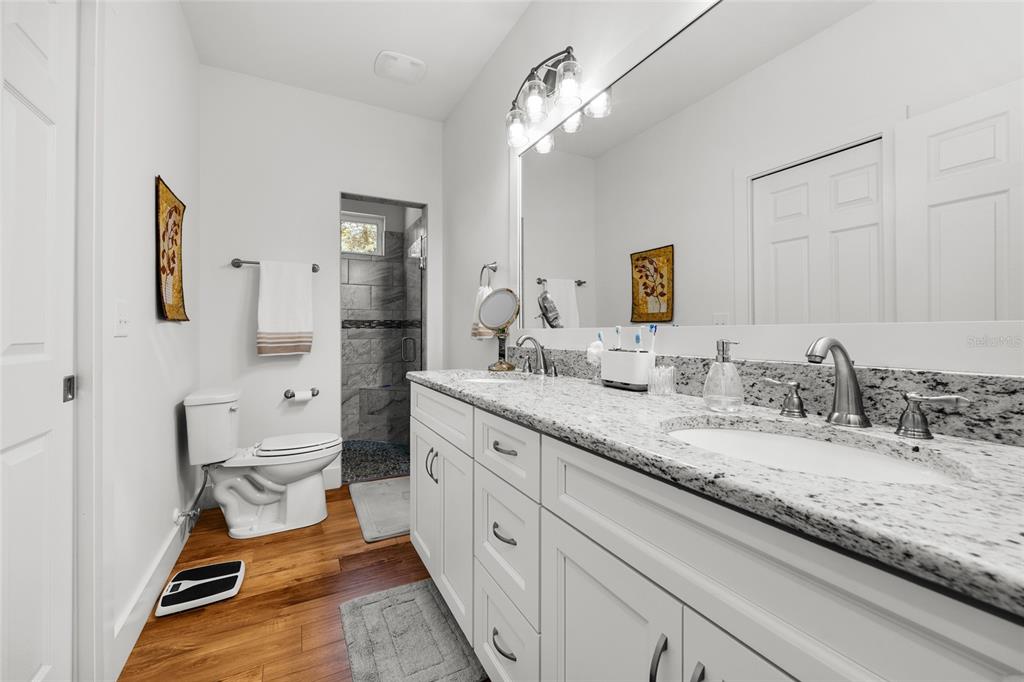 4162 Northeast 27th Lane High Springs, FL 32643 - Photo 22 of 46 a spacious bathroom with a granite countertop sink mirror and toilet