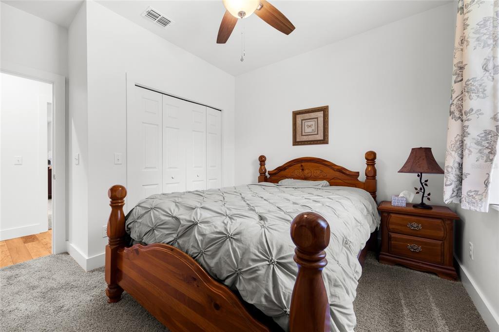 4162 Northeast 27th Lane High Springs, FL 32643 - Photo 25 of 46 a bedroom with a bed and wooden floor