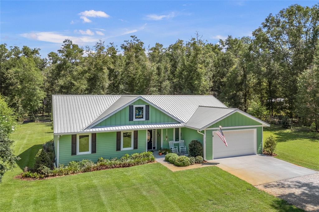 4162 Northeast 27th Lane High Springs, FL 32643 - Photo 36 of 46 a front view of a house with a yard and trees