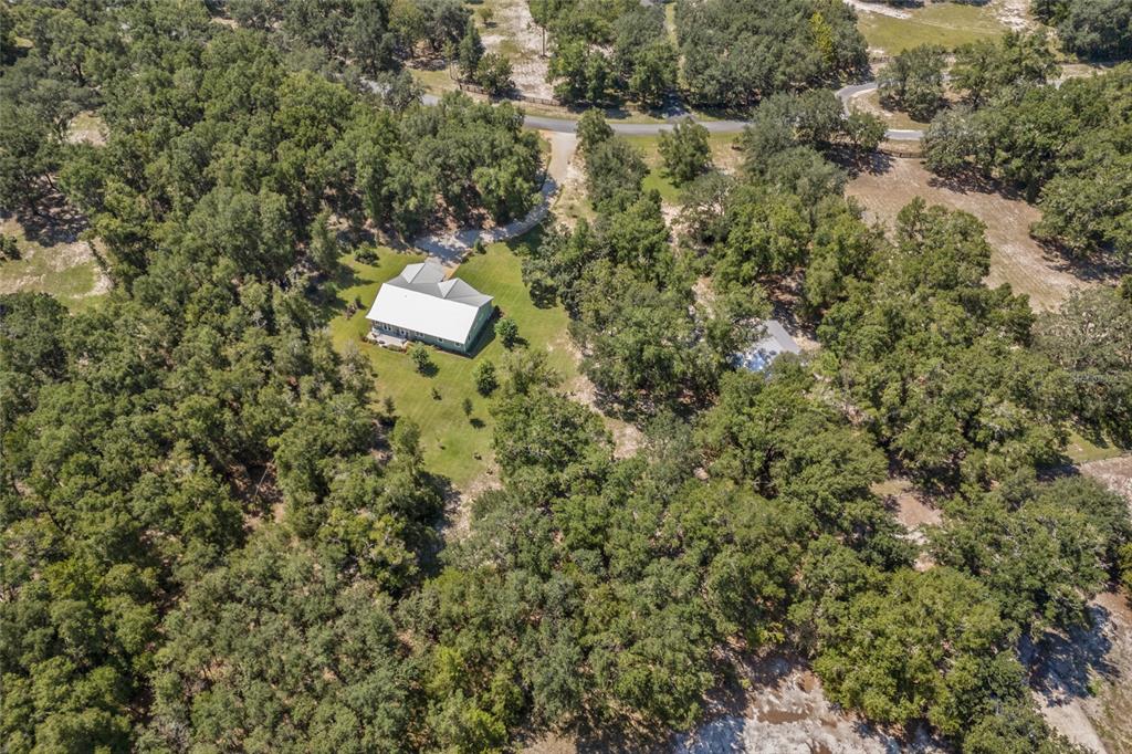 4162 Northeast 27th Lane High Springs, FL 32643 - Photo 46 of 46 a aerial view of a house with a yard and lake view