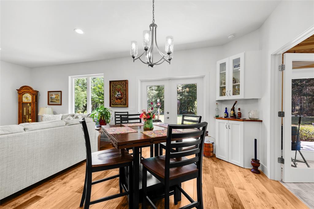 4162 Northeast 27th Lane High Springs, FL 32643 - Photo 9 of 46 a view of a dining room with furniture window and wooden floor