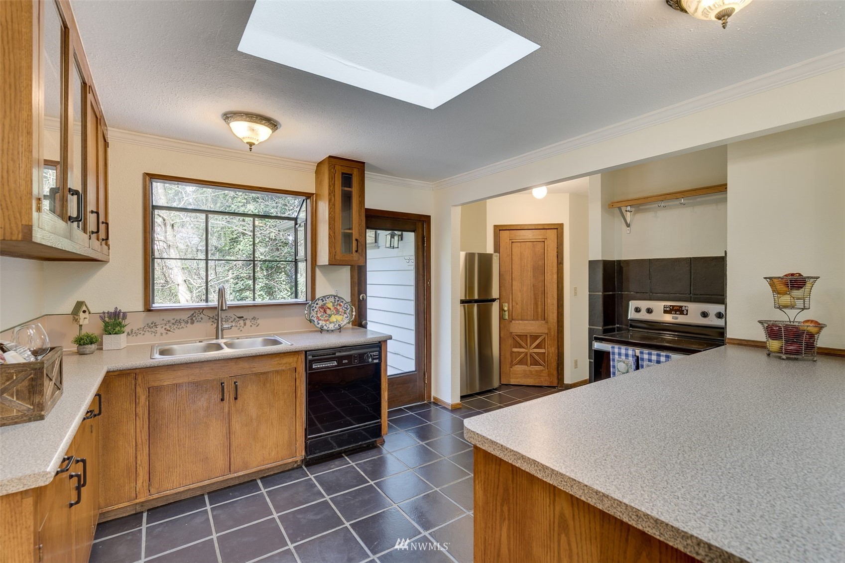 22925 2nd Avenue Southeast Bothell, WA 98021 - Photo 9 of 30 a kitchen with a sink a stove top oven a refrigerator cabinets and a dining table