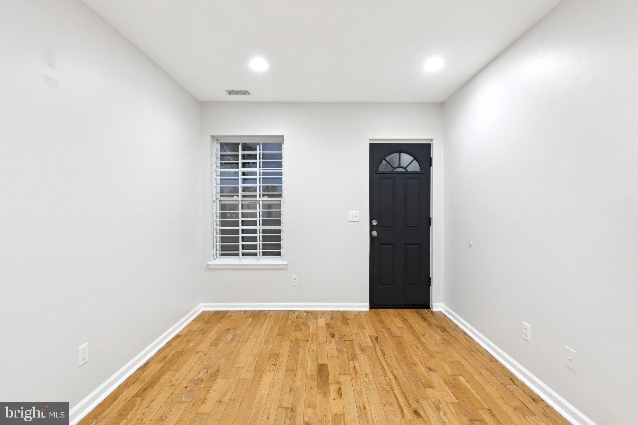1931 North Uber Street, Unit 2 Philadelphia, PA 19121 - Photo 16 of 26 a view of an empty room with wooden floor and a window