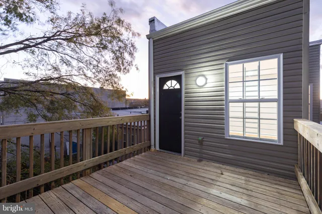 an empty room with window and ceiling fan