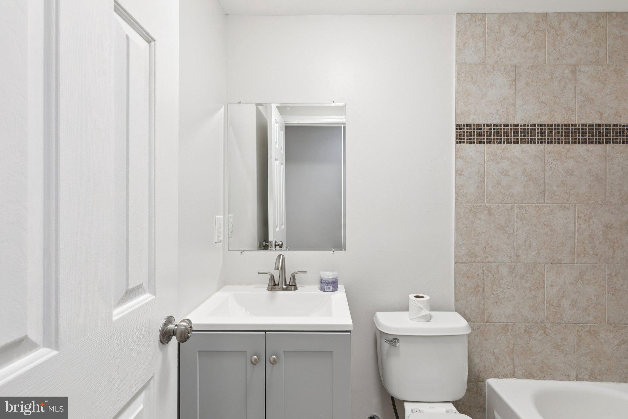 1931 North Uber Street, Unit 2 Philadelphia, PA 19121 - Photo 7 of 26 a bathroom with a sink toilet and mirror