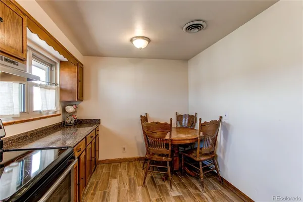 a view of a dining room with furniture and a window