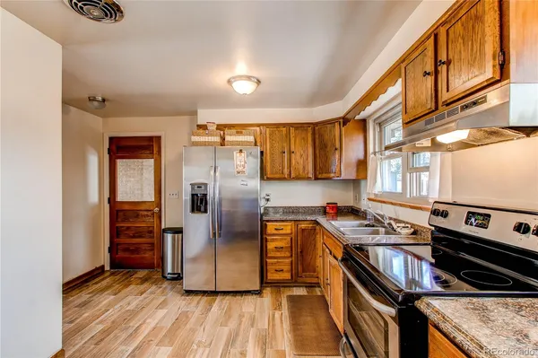 a kitchen with stainless steel appliances granite countertop a stove and a refrigerator