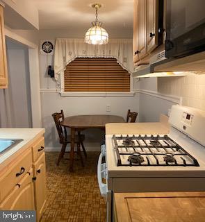 743 Bennington Road Folcroft, PA 19032 - Photo 8 of 22 a kitchen with a stove a table and chairs