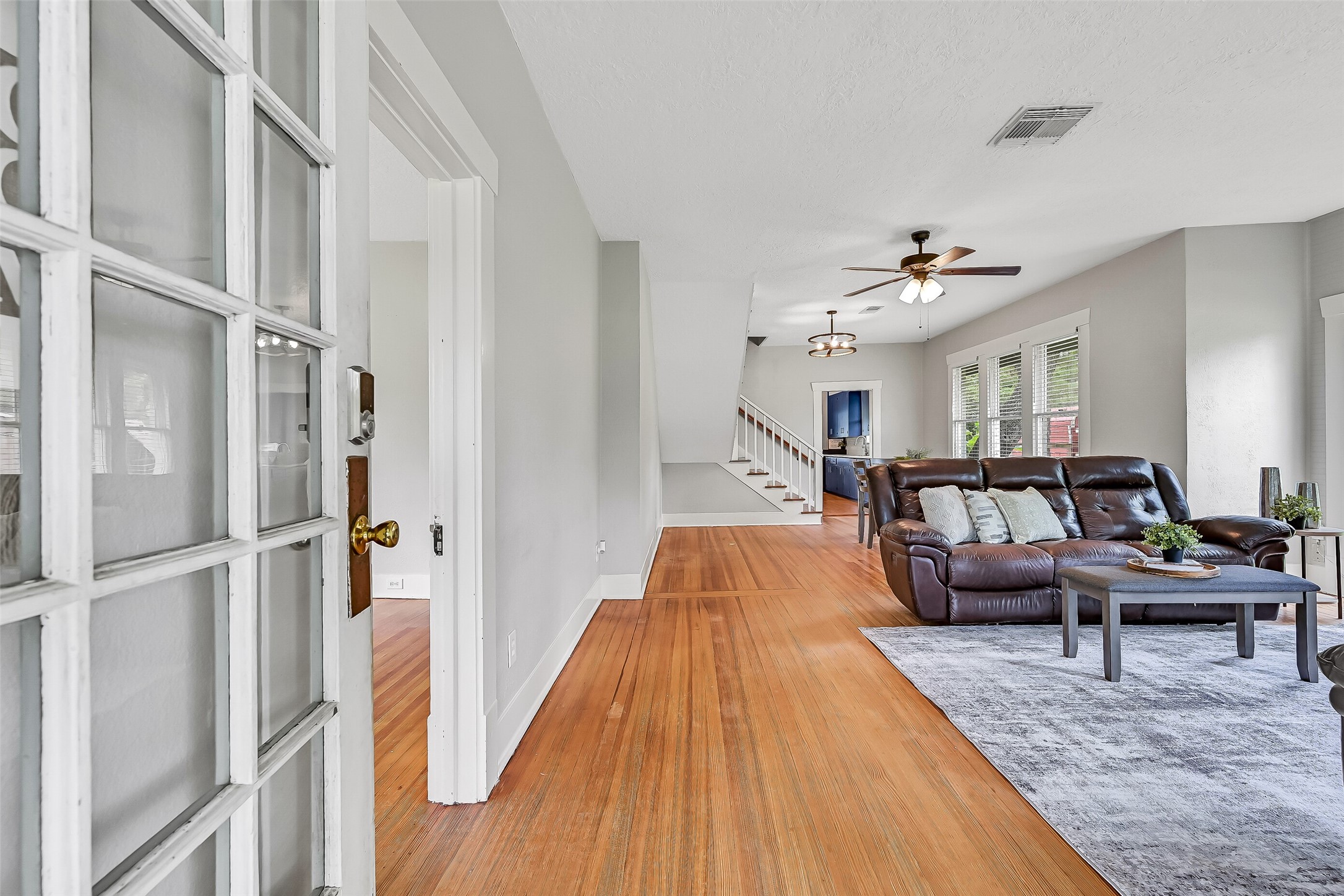 16724 Harkey Road Pearland, TX 77584 - Photo 11 of 34 Step inside and enjoy the family room with abundant natural light through 6 foot windows, original hardwood flooring, and cool paint tones.
