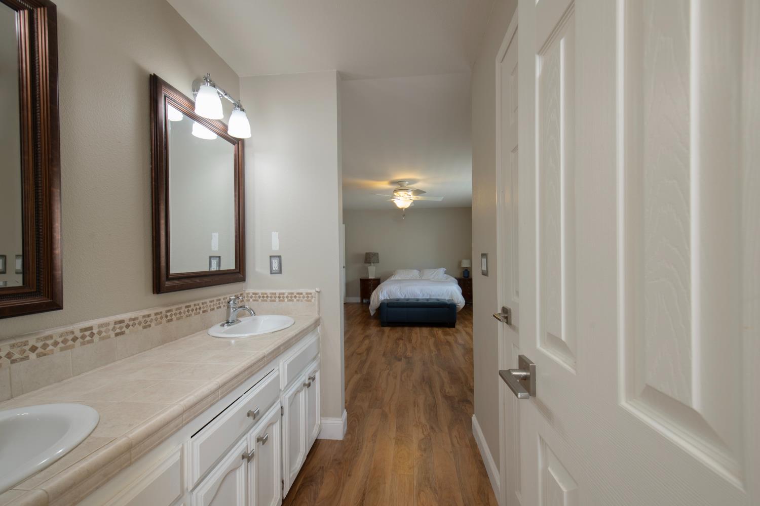 29395 Revis Road Coarsegold, CA 93614 - Photo 8 of 32 a en suite bathroom with a double vanity sink and a mirror