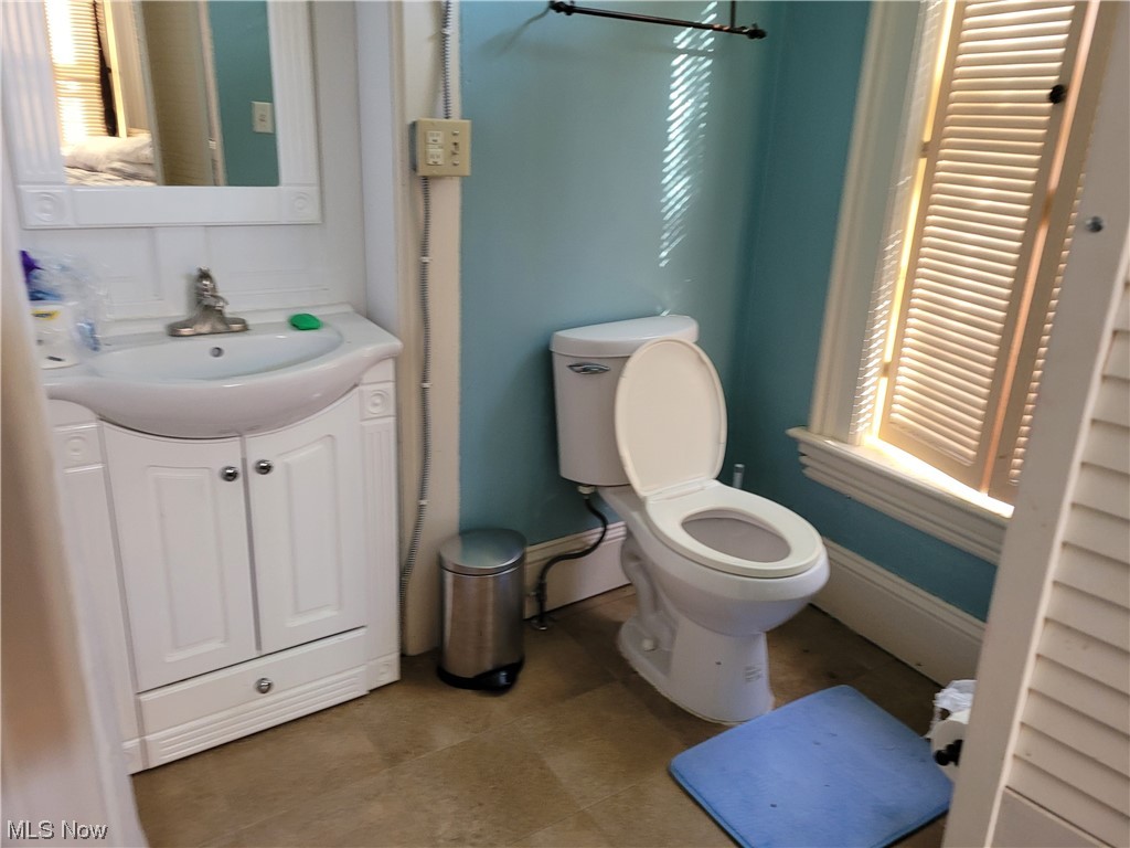 8957 Tinney Road Dennison, OH 44621 - Photo 20 of 26 Bathroom featuring tile flooring, toilet, and vanity