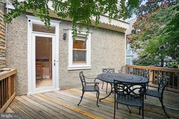 a view of a patio with table and chairs and wooden floor