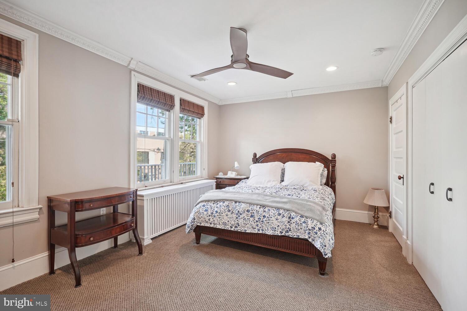 2924 Newark Street Northwest Washington, DC 20008 - Photo 15 of 26 a bedroom with a bed and a chandelier
