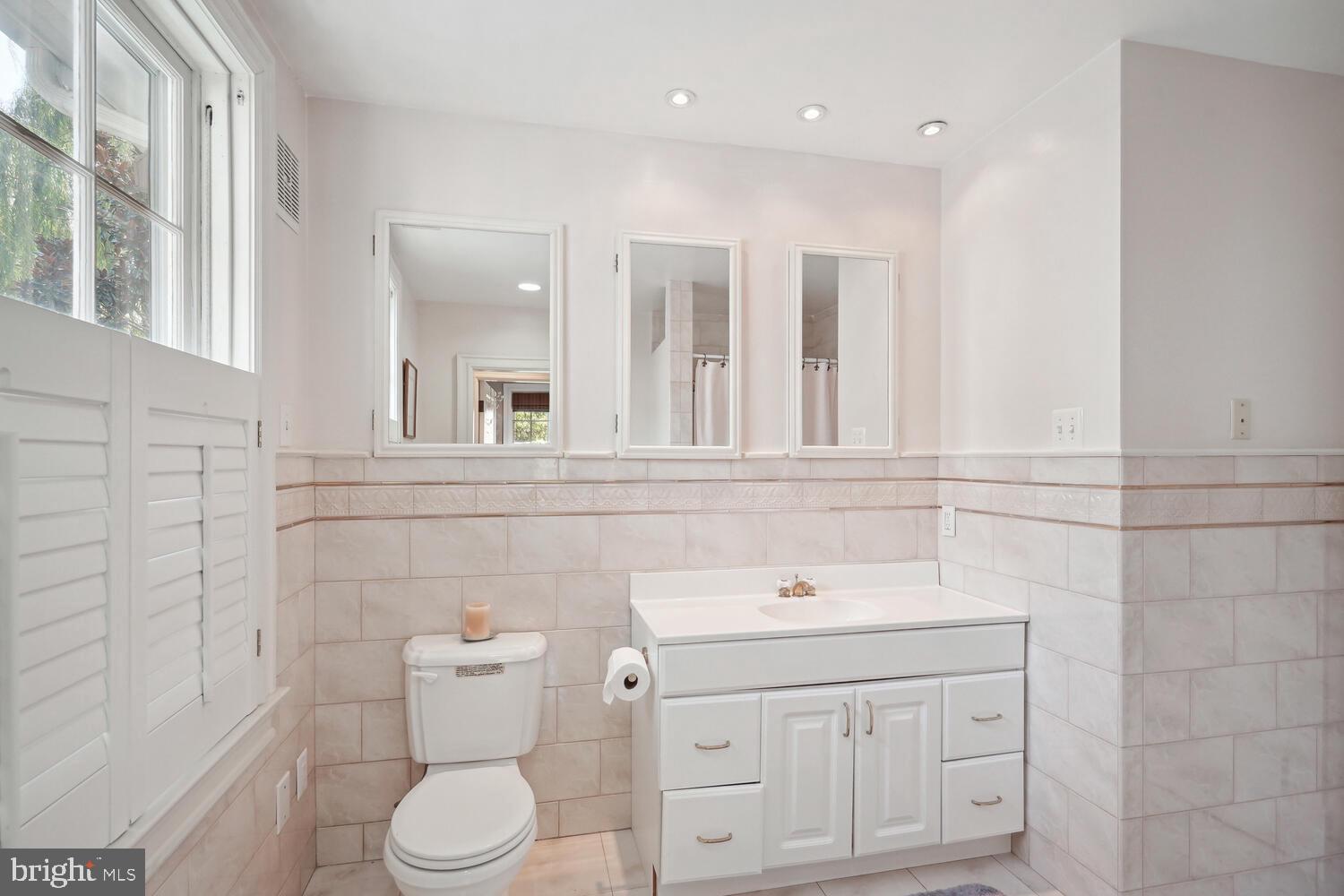 2924 Newark Street Northwest Washington, DC 20008 - Photo 16 of 26 a bathroom with a sink a toilet and a mirror