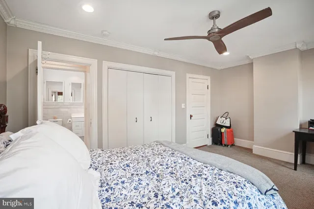 a bedroom with a bed and a dresser in it