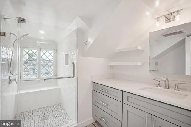 a bathroom with a tub sink and mirror