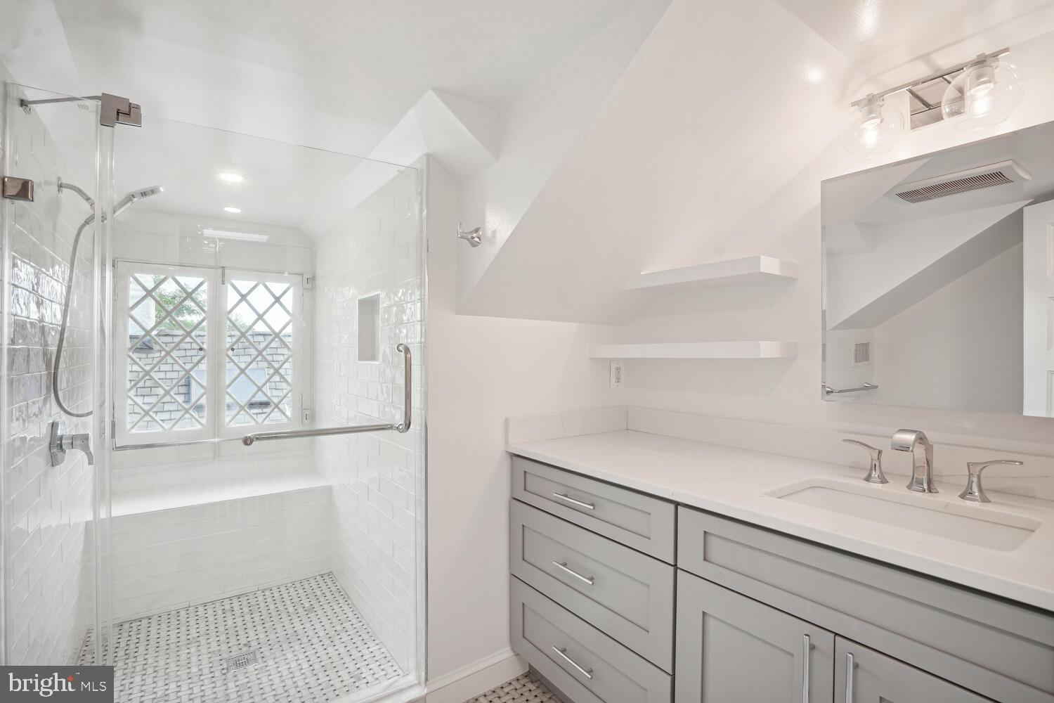 2924 Newark Street Northwest Washington, DC 20008 - Photo 22 of 26 a bathroom with a tub sink and mirror
