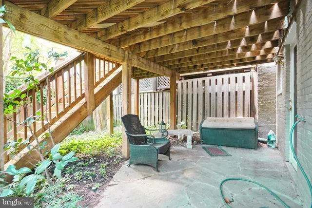 a balcony with furniture and a potted plant