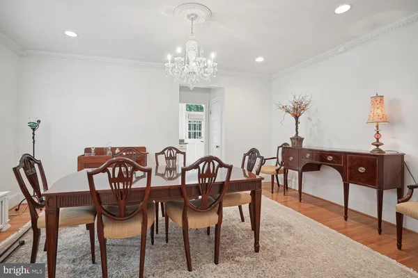 a view of a dining room with furniture and chandelier