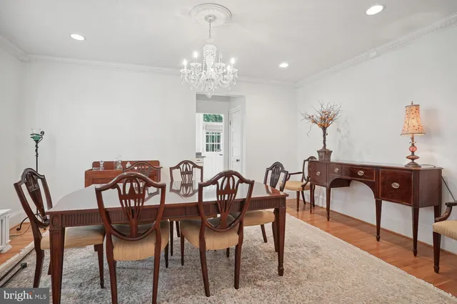 a view of a dining room with furniture and chandelier