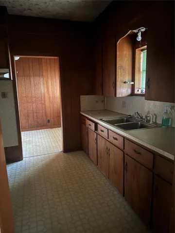 a bathroom with a sink a mirror and cabinets