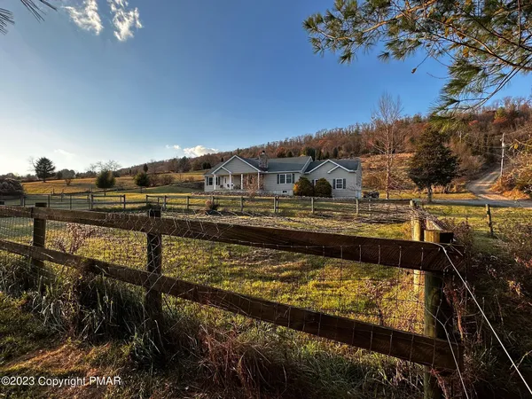 a large kitchen with stainless steel appliances a refrigerator a stove top oven and a sink