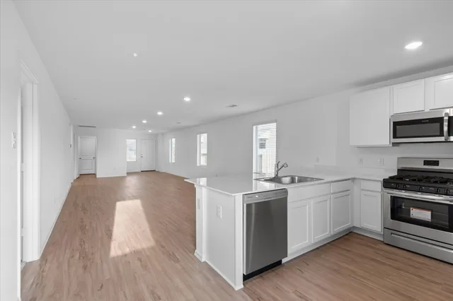 a kitchen with stainless steel appliances granite countertop a stove and a sink