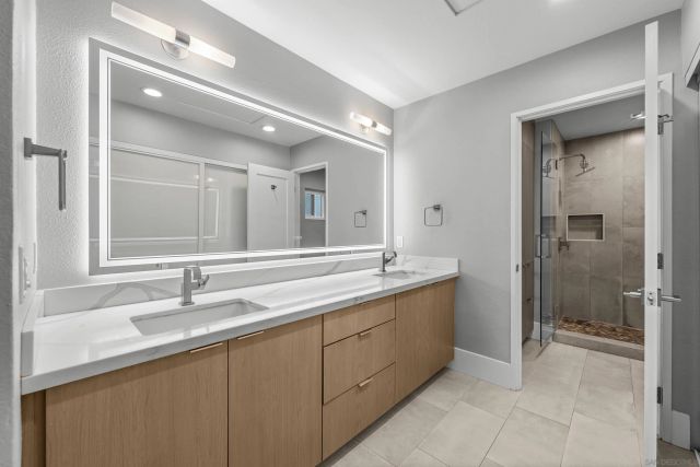a bathroom with a granite countertop sink mirror and double