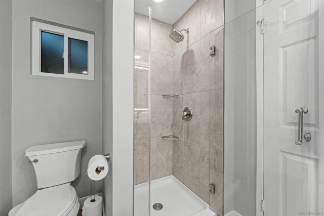 a bathroom with a toilet and shower