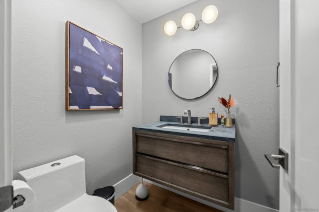 a bathroom with a toilet a sink and mirror