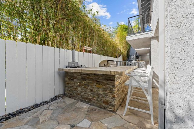 a view of balcony with a table and chairs