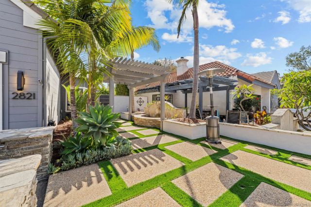 a view of a patio with couches table and chairs with wooden fence