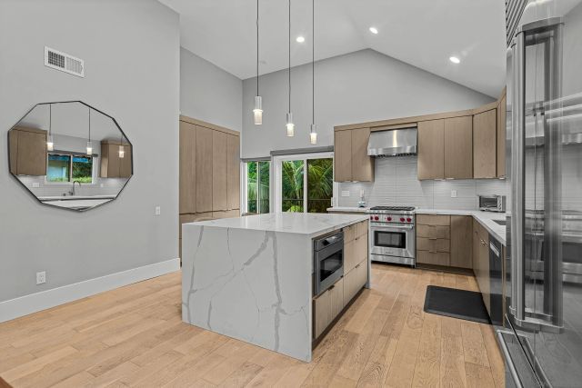 a kitchen with a stove a sink and a refrigerator
