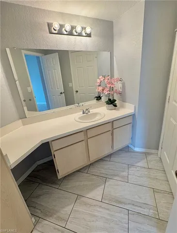 a bathroom with a sink vanity and mirror