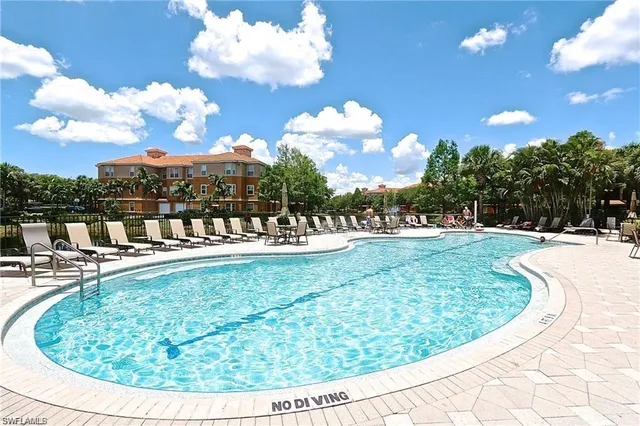 a view of a swimming pool with outdoor seating