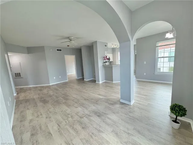 wooden floor with a chandelier fan